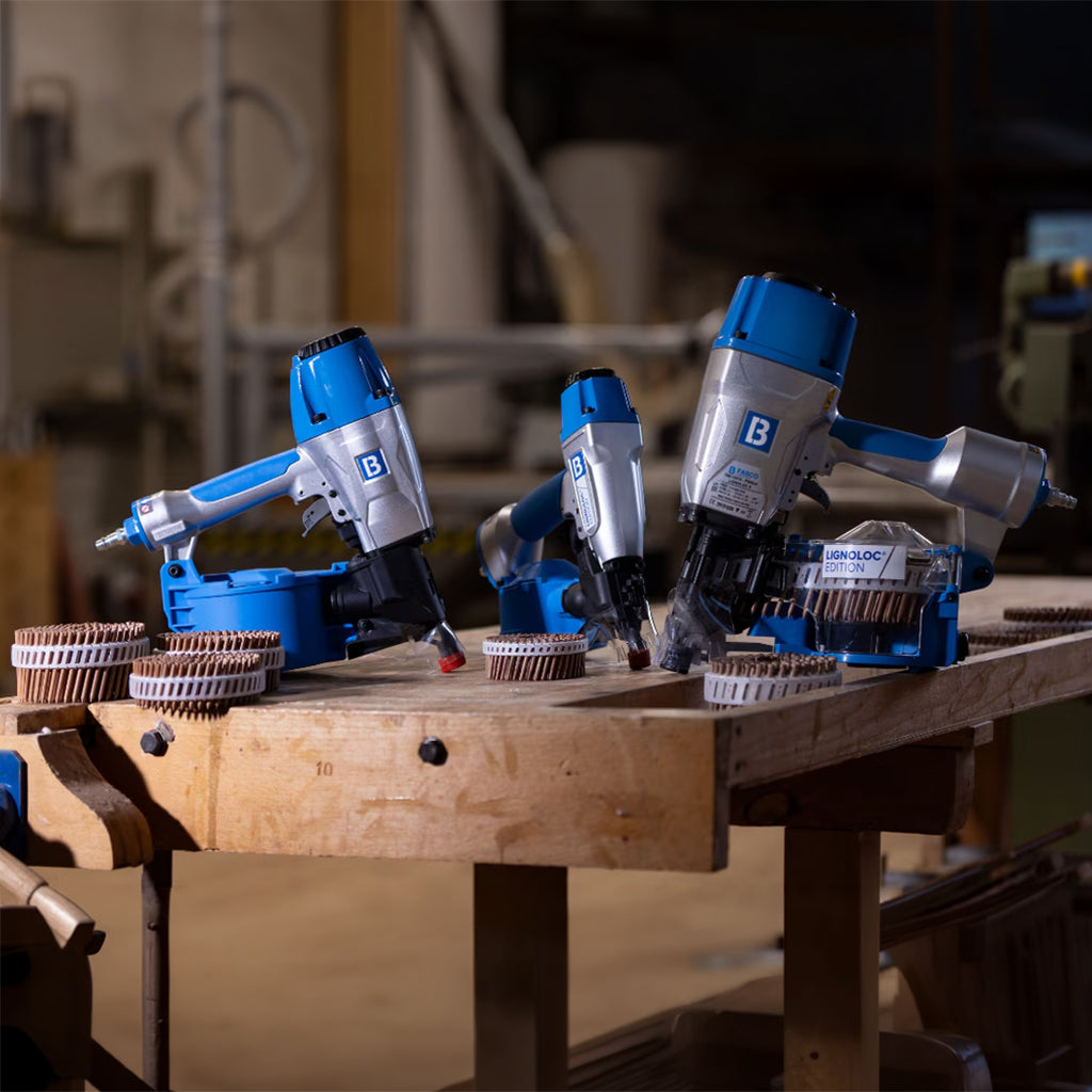 Full complement of LIGNOLOC Pneumatic Coil Nailers with Wooden Nails in the system displayed on a workbench.