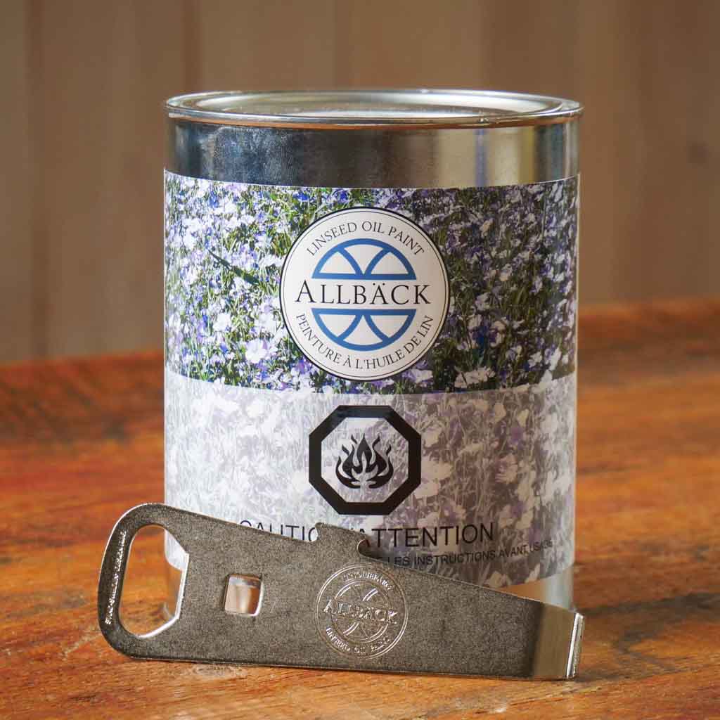 Allback paint can with a paint can opener on a wooden surface.