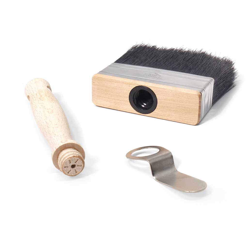 A disassembled paint brush with three parts and black bristles.