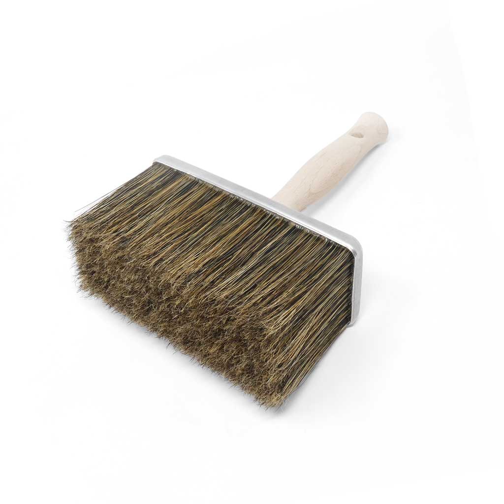 Brush with wooden handle and bristle head on a white background