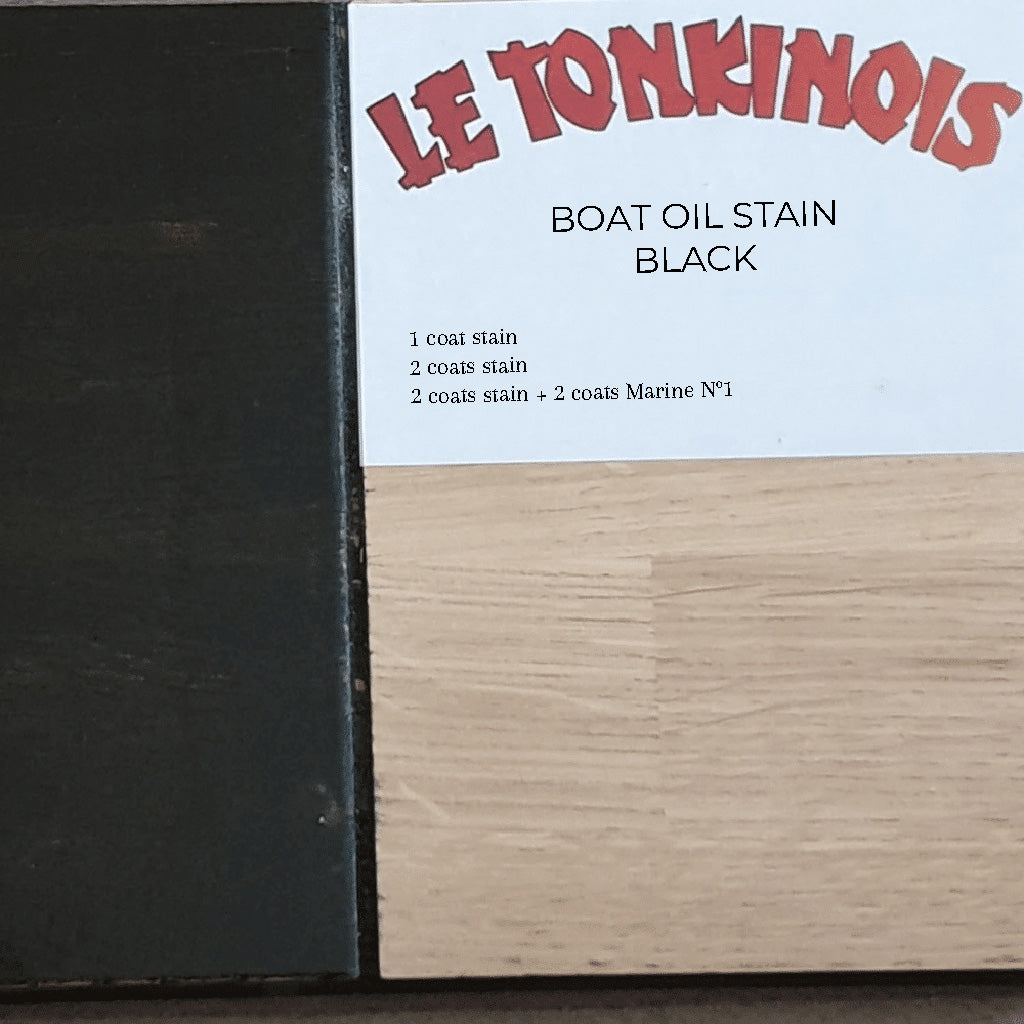 Close-up of a drawdown sample on a wooden surface showing the saturation of different coats of Le Tonkinois Boat Oil Stain in Black.