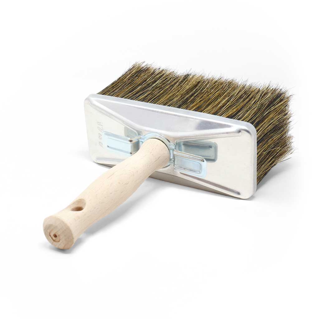 Oil and stain brush with wooden handle and metal frame on a white background