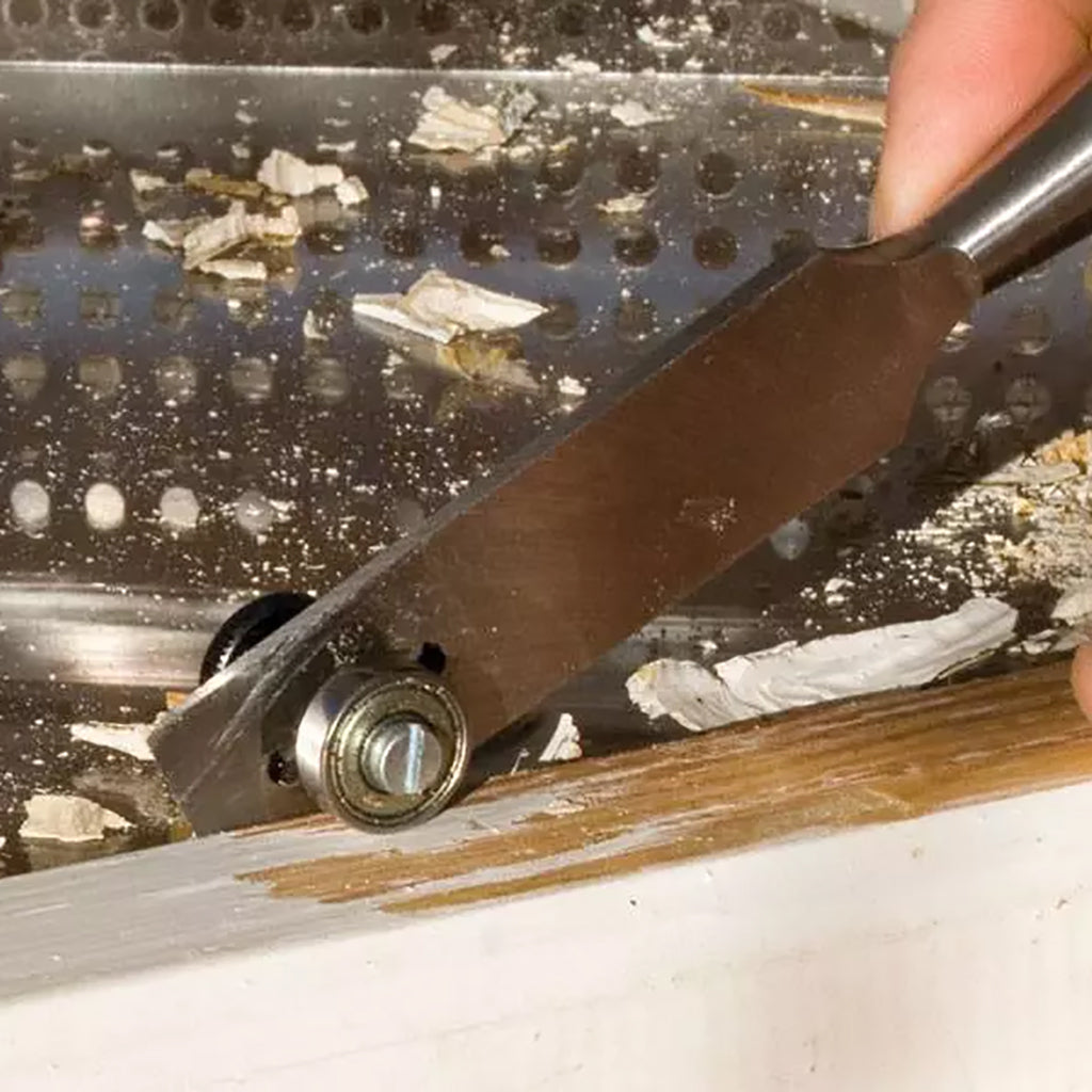 Speedheater Putty Chisel gliding along window stile and removing old putty.