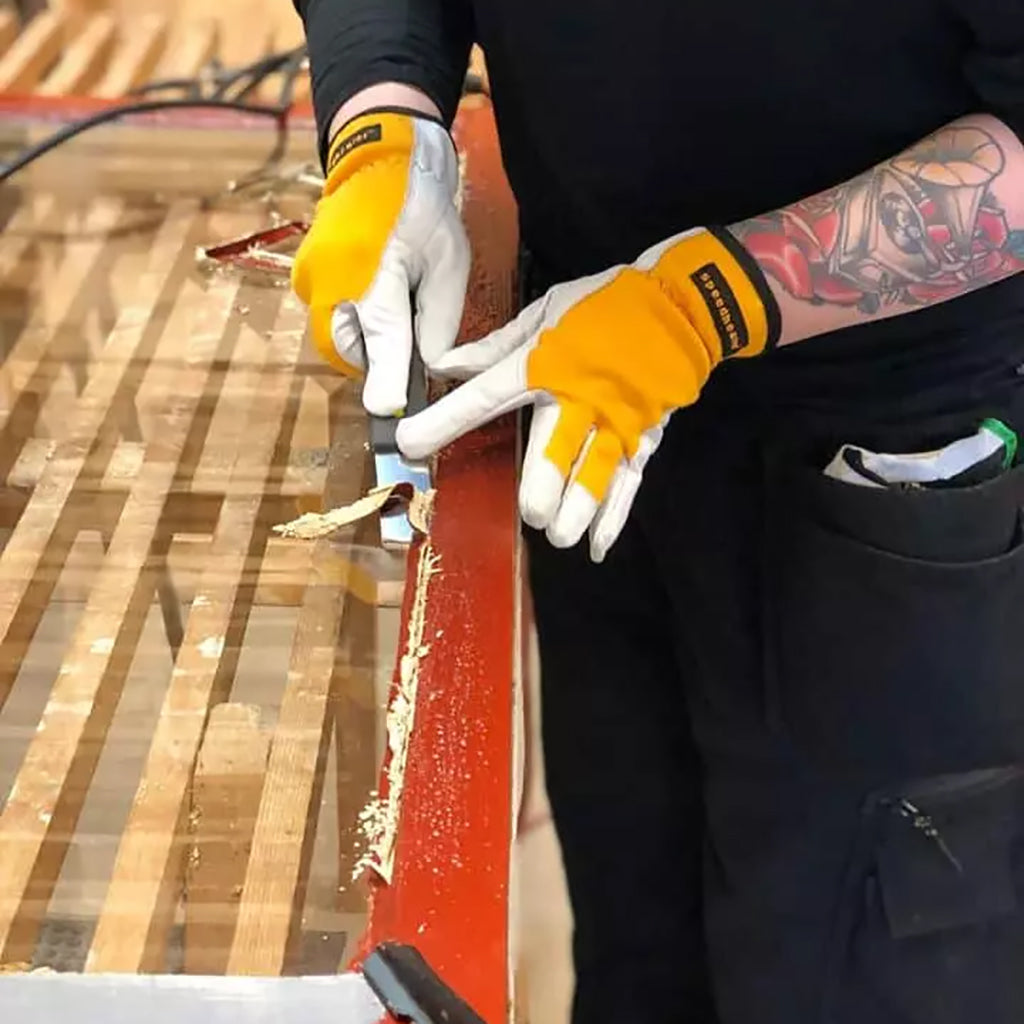 Removing putty from an old window with the Speedheater Putty Scraper.