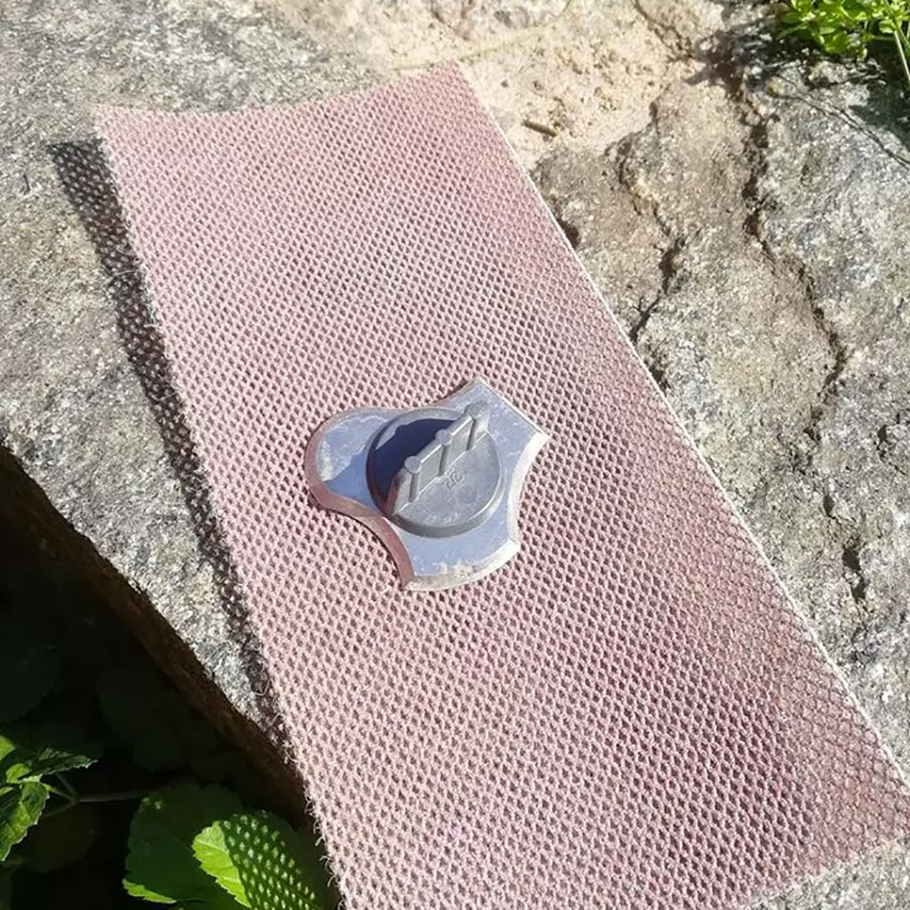 Sharpening a Speedheater Profile Scraper Blade on their diamond grinding pad.