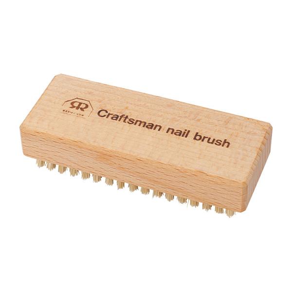 Natural wood brush with craftsman nail brush printed on it.