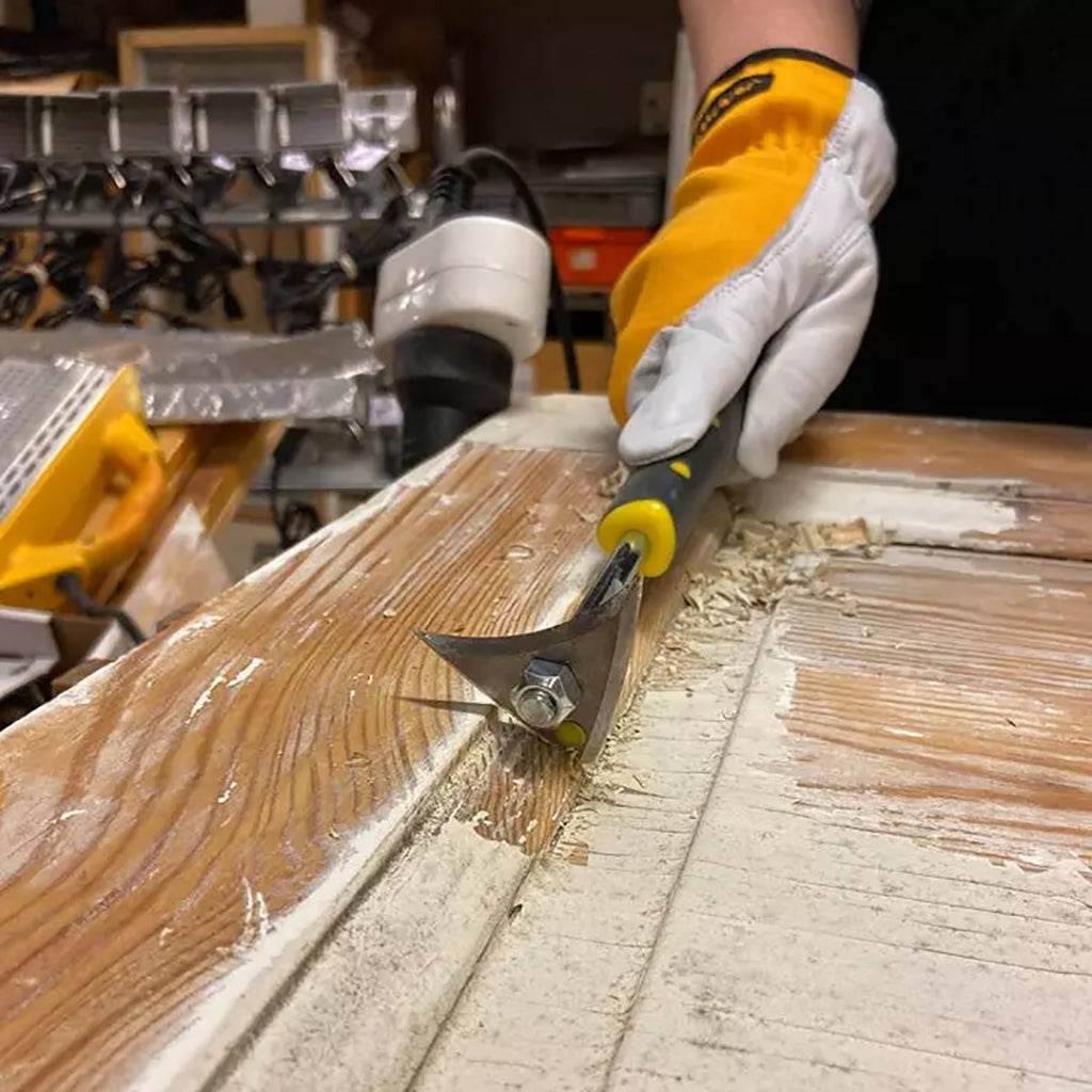 Closeup of scraping paint off an old door using the Speedheater Boomerang Scraper.