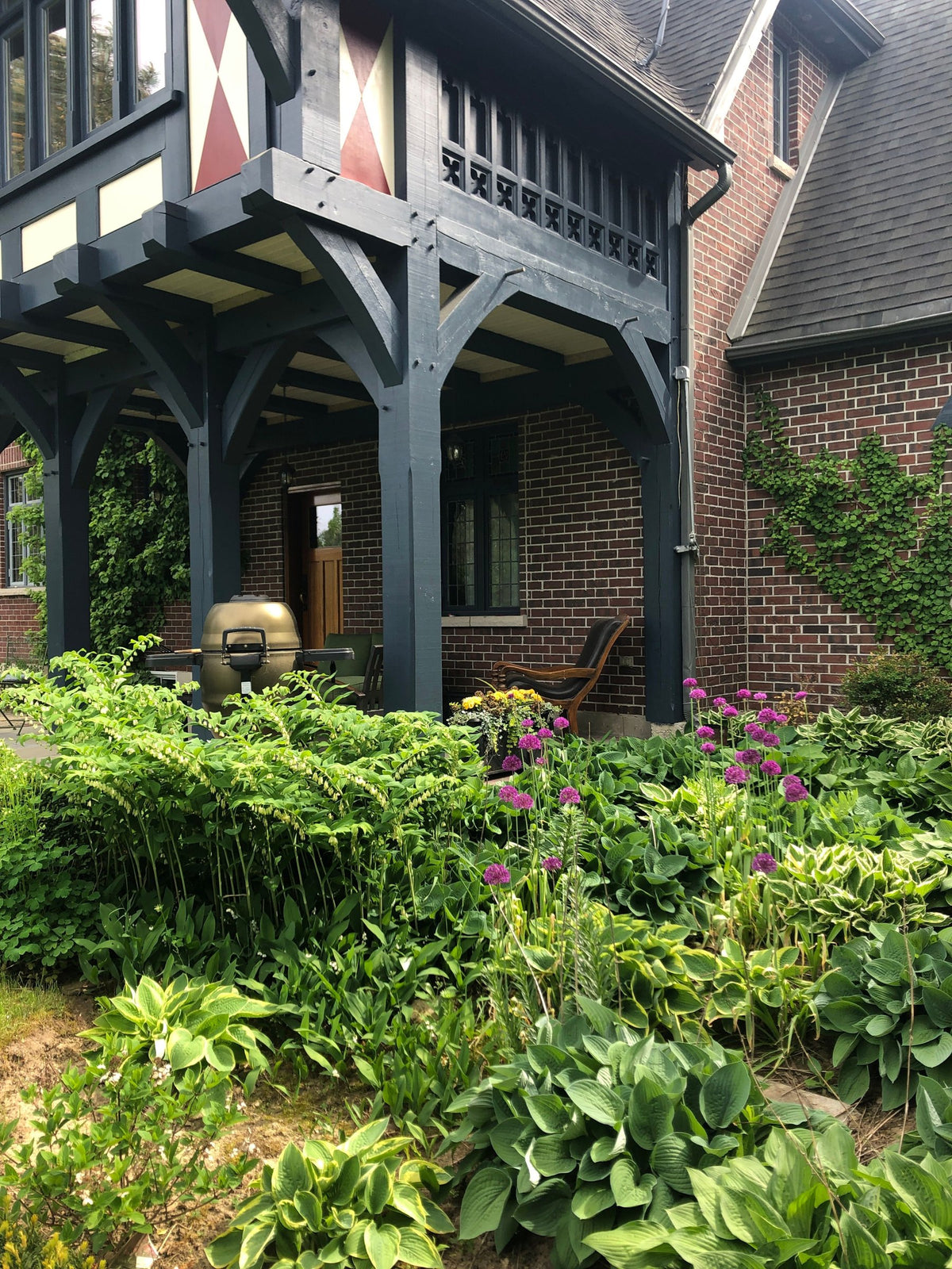 Dark painted porch timbers against brick