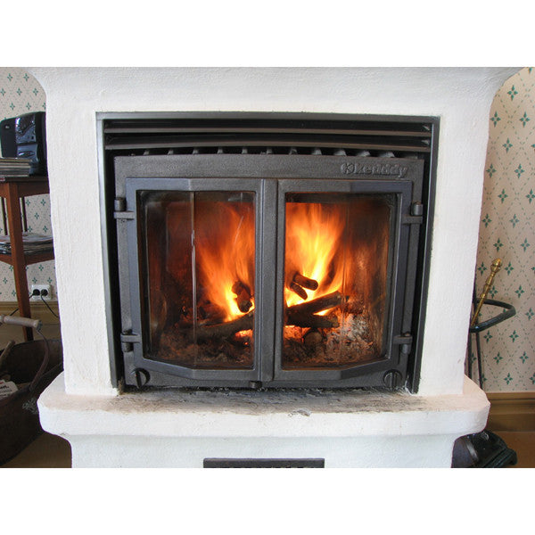 Metal around doors and trim of fireplace insert rejuvenated with Allbäck Linseed Oil Stove Blacking Fireplace Paint.